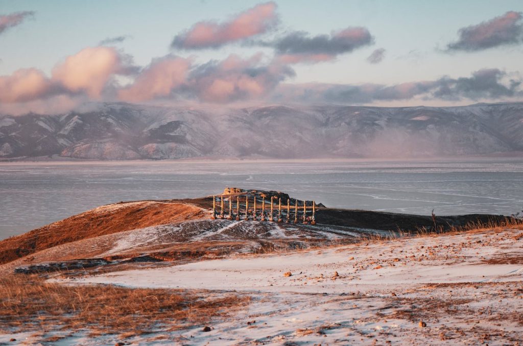 Beautiful winter landscape featuring sacred ritual poles against a mountainous backdrop.