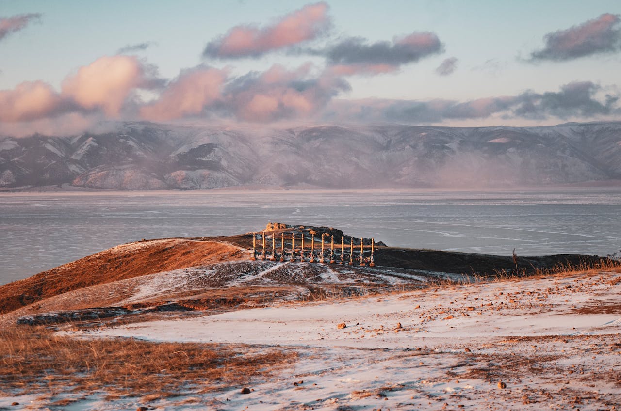 Beautiful winter landscape featuring sacred ritual poles against a mountainous backdrop.